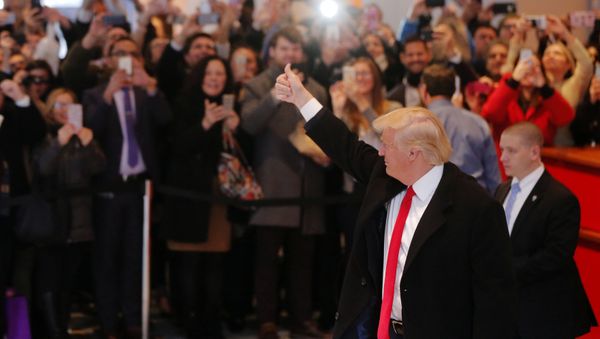 U.S. President elect Donald Trump reacts to a crowd gathered in the lobby of the New York Times building after a meeting in New York - Sputnik International