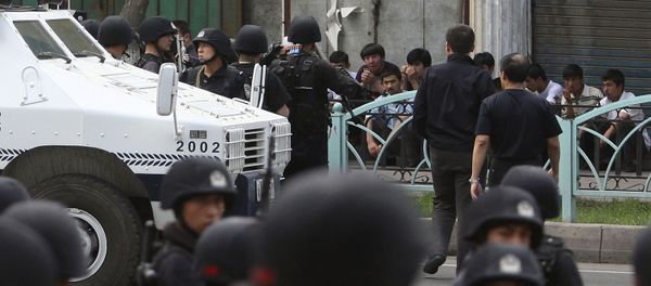 Uyghur protesters, sitting, are detained by security force officers after they marched to protest through the street in Urumqi, western China's Xinjiang province (File) - Sputnik International