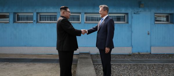 (FILES) This file photo taken on April 27, 2018 shows North Korea's leader Kim Jong Un (L) shaking hands with South Korea's President Moon Jae-in (R) at the Military Demarcation Line that divides their countries ahead of their summit at the truce village of Panmunjom (FILES) This file photo taken on April 27, 2018 shows North Korea's leader Kim Jong Un (L) shaking hands with South Korea's President Moon Jae-in (R) at the Military Demarcation Line that divides their countries ahead of their summit at the truce village of Panmunjom - Sputnik International