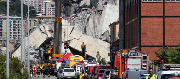 Firefighters and rescue workers stand at the site of a collapsed Morandi Bridge in the port city of Genoa, Italy August 15, 2018 Firefighters and rescue workers stand at the site of a collapsed Morandi Bridge in the port city of Genoa, Italy August 15, 2018 - Sputnik International