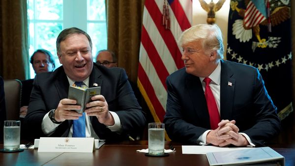 U.S. Secretary of State Mike Pompeo and U.S. President Donald Trump look at Pompeo's West Point cadet handbook from his time at the U.S. Military Academy in the 1980s after Pompeo read a prayer from the book at the start of a cabinet meeting at the White House in Washington, U.S., August 16, 2018. U.S. Secretary of State Mike Pompeo and U.S. President Donald Trump look at Pompeo's West Point cadet handbook from his time at the U.S. Military Academy in the 1980s after Pompeo read a prayer from the book at the start of a cabinet meeting at the White House in Washington, U.S., August 16, 2018. - Sputnik International
