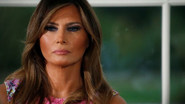 First lady Melania Trump listens as her husband U.S. President Donald Trump speaks at a dinner with business leaders at Trump National Golf Club in Bedminster, New Jersey, U.S., August 7, 2018 First lady Melania Trump listens as her husband U.S. President Donald Trump speaks at a dinner with business leaders at Trump National Golf Club in Bedminster, New Jersey, U.S., August 7, 2018 - Sputnik International