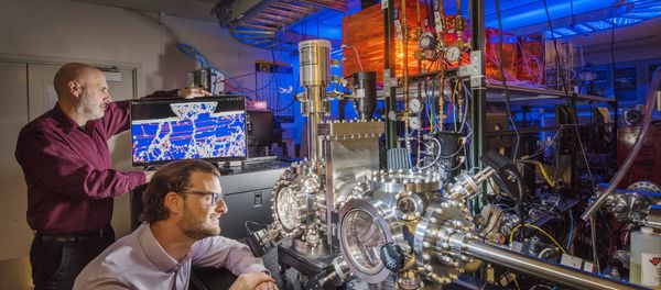 Sandia National Laboratories researchers Michael Chandross, left, and Nicolas Argibay show a computer simulation and an ultrahigh vacuum tribometer used in friction and wear testing Sandia National Laboratories researchers Michael Chandross, left, and Nicolas Argibay show a computer simulation and an ultrahigh vacuum tribometer used in friction and wear testing - Sputnik International