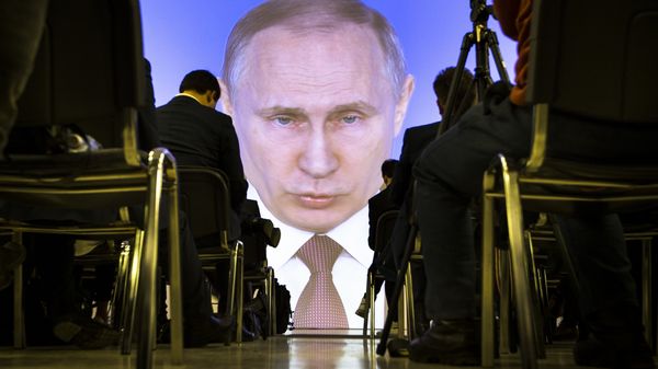 In this file photo taken Thursday, March 1, 2018, journalists watch as Russian President Vladimir Putin gives his annual state of the nation address in Manezh in Moscow, Russia. Buoyed by an oil boom, President Vladimir Putin's rule since 2000 has been marked by complaints about corruption and human rights abuse, tension with the West over Moscow's 2014 annexation of Crimea and accusations of meddling in U.S. elections - Sputnik International