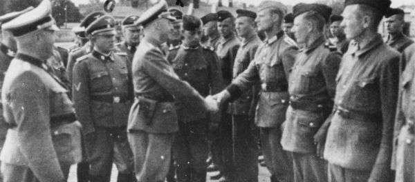 This 1942 photo provided by the the public prosecutor's office in Hamburg via the United States Holocaust Memorial Museum, shows Heinrich Himmler, center left, shaking hands with new guard recruits at the Trawniki concentration camp in Nazi occupied Poland. This 1942 photo provided by the the public prosecutor's office in Hamburg via the United States Holocaust Memorial Museum, shows Heinrich Himmler, center left, shaking hands with new guard recruits at the Trawniki concentration camp in Nazi occupied Poland. - Sputnik International