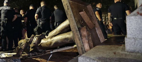 Police stand guard after the confederate statue known as Silent Sam was toppled by protesters on campus at the University of North Carolina in Chapel Hill, N.C., Monday, Aug. 20, 2018 - Sputnik International