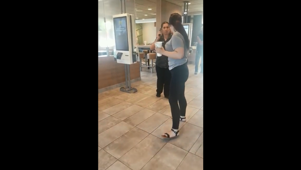 Cellphone footage shows McDonald's employee flinging phone at customer after being spat on - Sputnik International