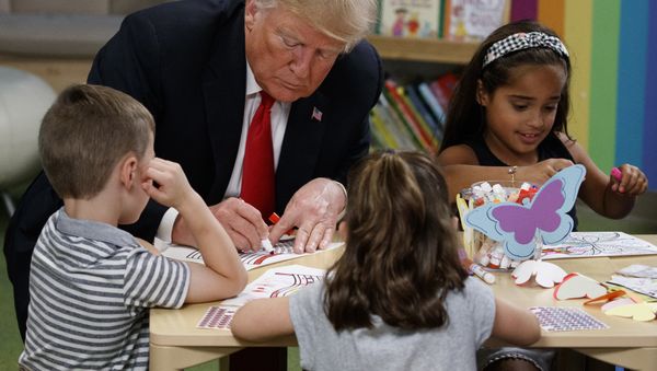 President Donald Trump colors pictures with a group of children at the Nationwide Children's Hospital, Friday, Aug. 24, 2018, in Columbus, Ohio - Sputnik International