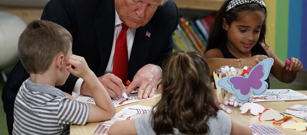 President Donald Trump colors pictures with a group of children at the Nationwide Children's Hospital, Friday, Aug. 24, 2018, in Columbus, Ohio - Sputnik International