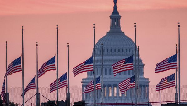 Flags flying a half-staff in honor of Sen. John McCain, R-Ariz., frame the U.S. Capital at daybreak in Washington, Sunday, Aug. 26, 2018. - Sputnik International