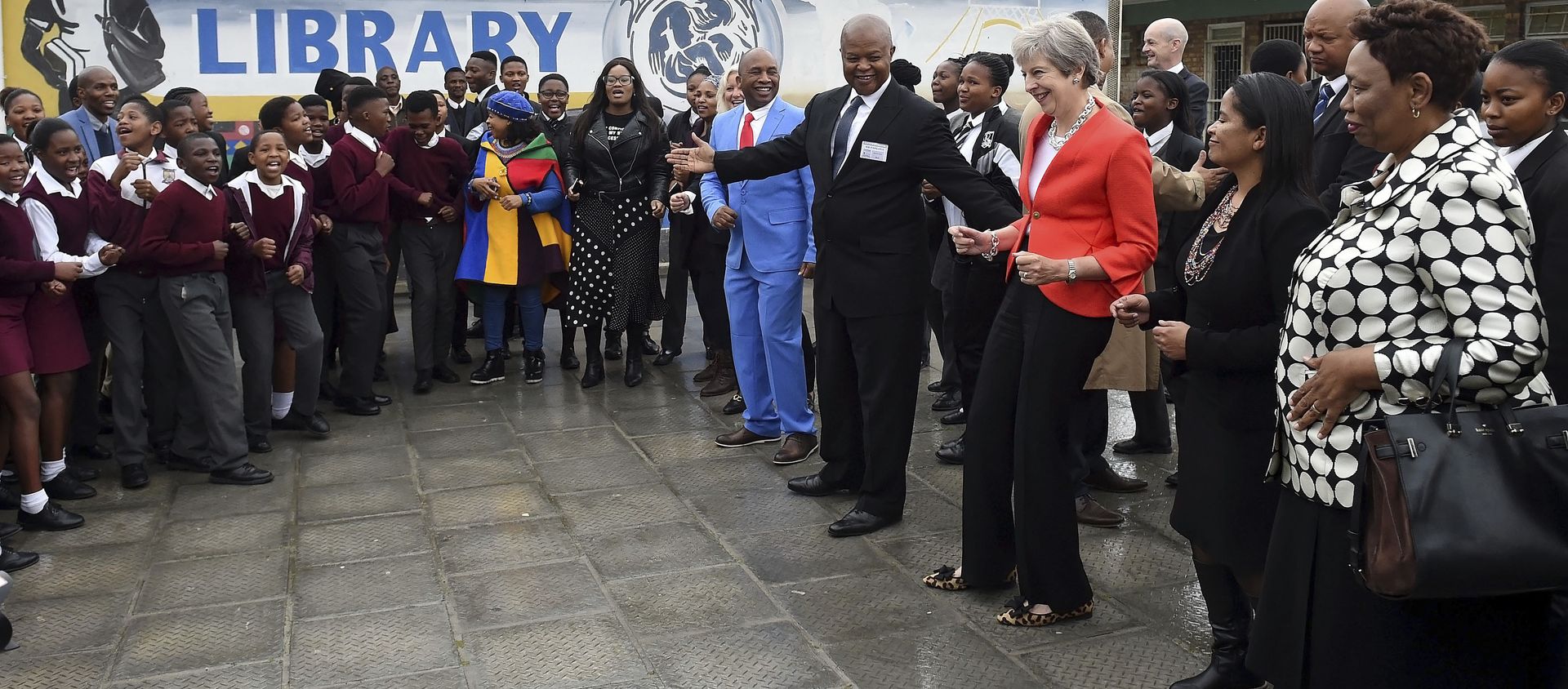 British Prime Minister Theresa May meets staff and pupils during a visit to the ID Mkhize High School in Gugulethu, Cape Town, South Africa, Tuesday, Aug. 28, 2018. Theresa May has started a three-nation visit to Africa where she is to meet South African President Cyril Ramaphosa British Prime Minister Theresa May meets staff and pupils during a visit to the ID Mkhize High School in Gugulethu, Cape Town, South Africa, Tuesday, Aug. 28, 2018. Theresa May has started a three-nation visit to Africa where she is to meet South African President Cyril Ramaphosa - Sputnik International, 1920, 28.08.2018