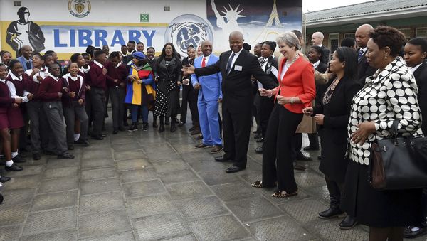 British Prime Minister Theresa May meets staff and pupils during a visit to the ID Mkhize High School in Gugulethu, Cape Town, South Africa, Tuesday, Aug. 28, 2018. Theresa May has started a three-nation visit to Africa where she is to meet South African President Cyril Ramaphosa British Prime Minister Theresa May meets staff and pupils during a visit to the ID Mkhize High School in Gugulethu, Cape Town, South Africa, Tuesday, Aug. 28, 2018. Theresa May has started a three-nation visit to Africa where she is to meet South African President Cyril Ramaphosa - Sputnik International