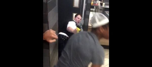 After a man in white is pictured kicking one of the police officers, another onlooker (pictured in grey with pink balloon in his mouth) approaches the two PCs After a man in white is pictured kicking one of the police officers, another onlooker (pictured in grey with pink balloon in his mouth) approaches the two PCs - Sputnik International