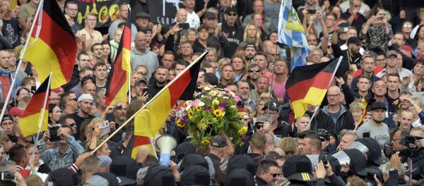Protesters carry a wreath as they gather for a far-right protest in Chemnitz, Germany, Monday, Aug. 27, 2018 after a man has died and two others were injured in an altercation between several people of various nationalities in the eastern German city of Chemnitz on Sunday Protesters carry a wreath as they gather for a far-right protest in Chemnitz, Germany, Monday, Aug. 27, 2018 after a man has died and two others were injured in an altercation between several people of various nationalities in the eastern German city of Chemnitz on Sunday - Sputnik International