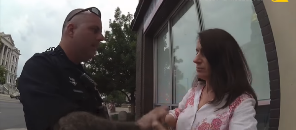 Body camera footage released by the Denver Police Department on Tuesday shows two cops telling independent reporter Susan Greene to “act like a lady” as they place her in handcuffs for filming them ‒ an act that is the constitutional right of every US citizen. Body camera footage released by the Denver Police Department on Tuesday shows two cops telling independent reporter Susan Greene to “act like a lady” as they place her in handcuffs for filming them ‒ an act that is the constitutional right of every US citizen. - Sputnik International