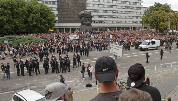 Protesters gather for a far-right protest in front of the Karl Marx Monument in Chemnitz, Germany, Monday, Aug. 27, 2018 after a man has died and two others were injured in an altercation between several people of various nationalities in the eastern German city of Chemnitz on Sunday Protesters gather for a far-right protest in front of the Karl Marx Monument in Chemnitz, Germany, Monday, Aug. 27, 2018 after a man has died and two others were injured in an altercation between several people of various nationalities in the eastern German city of Chemnitz on Sunday - Sputnik International