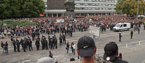 Protesters gather for a far-right protest in front of the Karl Marx Monument in Chemnitz, Germany, Monday, Aug. 27, 2018 after a man has died and two others were injured in an altercation between several people of various nationalities in the eastern German city of Chemnitz on Sunday Protesters gather for a far-right protest in front of the Karl Marx Monument in Chemnitz, Germany, Monday, Aug. 27, 2018 after a man has died and two others were injured in an altercation between several people of various nationalities in the eastern German city of Chemnitz on Sunday - Sputnik International