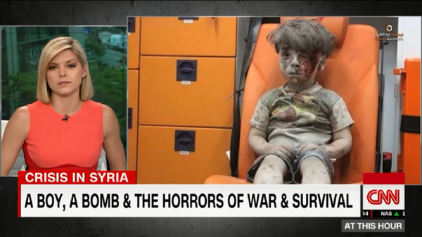 CNN anchor Kate Bolduan chokes up after Omran Daqneesh, 5, was injured in an alleged airstrike. The boy's father came out in support of Assad and criticized rebel groups for using his son's image as propaganda in June 2017. CNN anchor Kate Bolduan chokes up after Omran Daqneesh, 5, was injured in an alleged airstrike. The boy's father came out in support of Assad and criticized rebel groups for using his son's image as propaganda in June 2017. - Sputnik International