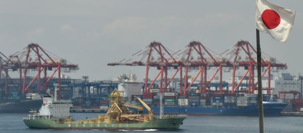 The Japanese national flag is seen at a cargo terminal area of Tokyo port on June 8, 2016. Japan's economy expanded at a slightly faster pace than first thought, revised figures showed June 8, knocking hopes that the central bank will unleash fresh stimulus this month. - Sputnik International