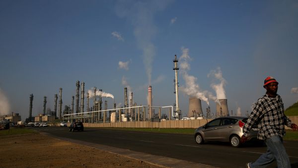 A man walks past South African petrochemical company Sasol's synthetic fuel plant in Secunda, north of Johannesburg (File) A man walks past South African petrochemical company Sasol's synthetic fuel plant in Secunda, north of Johannesburg (File) - Sputnik International