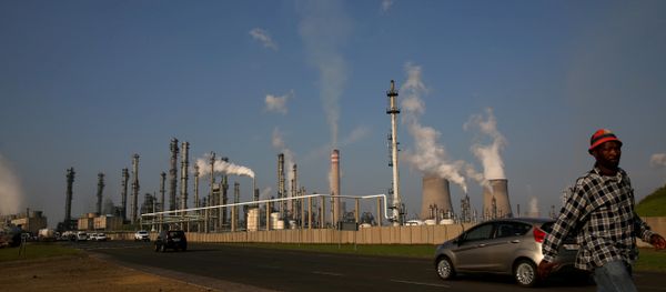 A man walks past South African petrochemical company Sasol's synthetic fuel plant in Secunda, north of Johannesburg (File) A man walks past South African petrochemical company Sasol's synthetic fuel plant in Secunda, north of Johannesburg (File) - Sputnik International