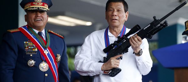 April 19, 2018 file photo, Philippine President Rodrigo Duterte, right, jokes to photographers as he holds an Israeli-made Galil rifle which was presented to him by former Philippine National Police Chief Director General Ronald Bato Dela Rosa at the turnover-of-command ceremony at the Camp Crame in Quezon city northeast of Manila April 19, 2018 file photo, Philippine President Rodrigo Duterte, right, jokes to photographers as he holds an Israeli-made Galil rifle which was presented to him by former Philippine National Police Chief Director General Ronald Bato Dela Rosa at the turnover-of-command ceremony at the Camp Crame in Quezon city northeast of Manila - Sputnik International