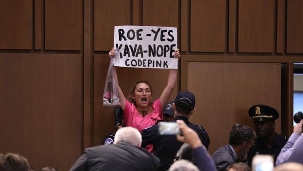 A protester is removed during the start of U.S. Supreme Court nominee judge Brett Kavanaugh's Senate Judiciary Committee confirmation hearing on Capitol Hill in Washington, U.S., September 4, 2018 - Sputnik International