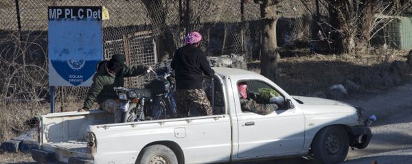 A group of men, not specified which group of rebels, drive into an abandoned UN post at Syria's Quneitra border crossing between Syria and the Israeli-controlled Golan Heights, seen from the Israeli-controlled Golan Heights, Monday, Nov. 28, 2016. A group of men, not specified which group of rebels, drive into an abandoned UN post at Syria's Quneitra border crossing between Syria and the Israeli-controlled Golan Heights, seen from the Israeli-controlled Golan Heights, Monday, Nov. 28, 2016. - Sputnik International