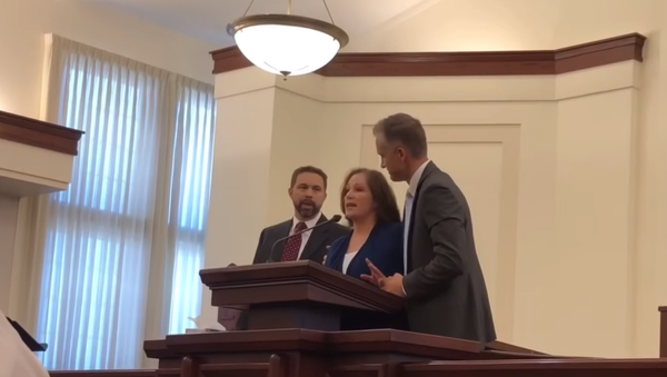 McKenna Denson speaks out at monthly fast-and-testimony meeting in Arizona and calls out her alleged abusers in front of congregants. - Sputnik International