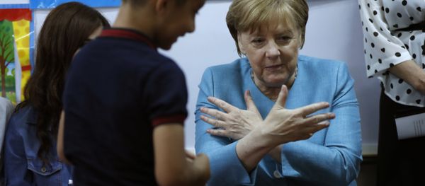 German Chancellor Angela Merkel, right, sits inside a classroom, as she speaks with Lebanese and Syrian displaced students where they studying together, during her visit to a Lebanese public school, in Beirut, Lebanon, Friday, June 22, 2018. Merkel is visiting Jordan and Lebanon, both neighbors of war-torn Syria, amid an escalating domestic row over migration German Chancellor Angela Merkel, right, sits inside a classroom, as she speaks with Lebanese and Syrian displaced students where they studying together, during her visit to a Lebanese public school, in Beirut, Lebanon, Friday, June 22, 2018. Merkel is visiting Jordan and Lebanon, both neighbors of war-torn Syria, amid an escalating domestic row over migration - Sputnik International