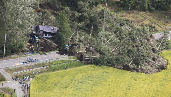 Police officers and rescue workers search for survivors from a building damaged by a landslide caused by a powerful earthquake in Atsuma town in Japan's northern island of Hokkaido, Japan, in this photo taken by Kyodo September 6, 2018. - Sputnik International