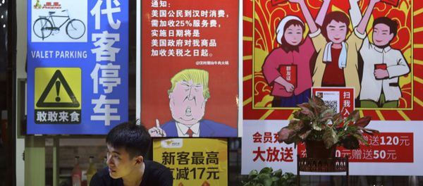 In this Monday, Aug. 13, 2018, photo, a man stands near a poster depicting a mural of U.S. President Donald Trump stating that all American costumers will be charged 25 percent more than others starting from the day president Trump started the trade war against China, on display outside a restaurant in Guangzhou in south China's Guangdong province. The recent trade war between the world's two biggest economies has forced many multinational companies to reschedule purchases and rethink where they buy materials and parts to try to dodge or blunt the effects of tit-for-tat tariffs between Washington and Beijing In this Monday, Aug. 13, 2018, photo, a man stands near a poster depicting a mural of U.S. President Donald Trump stating that all American costumers will be charged 25 percent more than others starting from the day president Trump started the trade war against China, on display outside a restaurant in Guangzhou in south China's Guangdong province. The recent trade war between the world's two biggest economies has forced many multinational companies to reschedule purchases and rethink where they buy materials and parts to try to dodge or blunt the effects of tit-for-tat tariffs between Washington and Beijing - Sputnik International