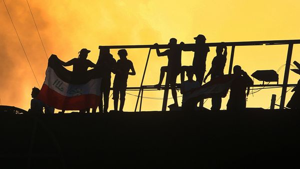 Protesters raise an Iraqi flag over the Basra Government building during a demonstration demanding better public services and jobs in Basra, 340 miles (550 km) southeast of Baghdad, Iraq, Friday, Sept. 7, 2018 - Sputnik International