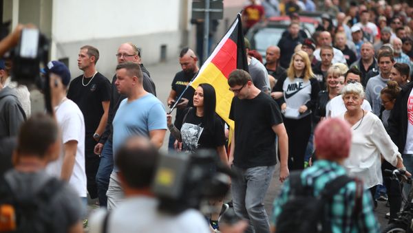 People attend a right wing protest in Koethen, Germany, September 9, 2018, after a 22-year-old German man died overnight in the eastern town of Koethen and two Afghans have been detained on suspicion of killing him. People attend a right wing protest in Koethen, Germany, September 9, 2018, after a 22-year-old German man died overnight in the eastern town of Koethen and two Afghans have been detained on suspicion of killing him. - Sputnik International