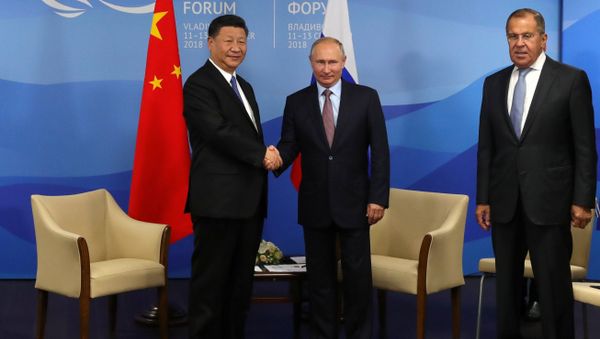 September 11, 2018. President Vladimir Putin and Chinese President Xi Jinping, left, during a meeting on the sidelines of the 4th Eastern Economic Forum at the Far Eastern Federal University on the Russky Island. Right: Foreign Minister Sergei Lavrov September 11, 2018. President Vladimir Putin and Chinese President Xi Jinping, left, during a meeting on the sidelines of the 4th Eastern Economic Forum at the Far Eastern Federal University on the Russky Island. Right: Foreign Minister Sergei Lavrov - Sputnik International