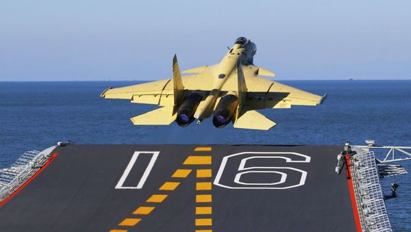 In this undated photo released by China's Xinhua News Agency, made available on Sunday, Nov. 25, 2012, a carrier-borne J-15 fighter jet takes off from China's first aircraft carrier, the Liaoning. China has successfully landed a fighter jet on its first aircraft carrier, which entered service two months ago, the country's official news agency confirmed Sunday. The Liaoning aircraft carrier underscores China's ambitions to be a leading Asian naval power, but it is not expected to carry a full complement of planes or be ready for combat for some time. - Sputnik International