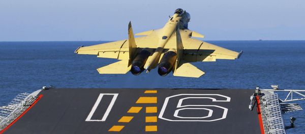In this undated photo released by China's Xinhua News Agency, made available on Sunday, Nov. 25, 2012, a carrier-borne J-15 fighter jet takes off from China's first aircraft carrier, the Liaoning. China has successfully landed a fighter jet on its first aircraft carrier, which entered service two months ago, the country's official news agency confirmed Sunday. The Liaoning aircraft carrier underscores China's ambitions to be a leading Asian naval power, but it is not expected to carry a full complement of planes or be ready for combat for some time. - Sputnik International