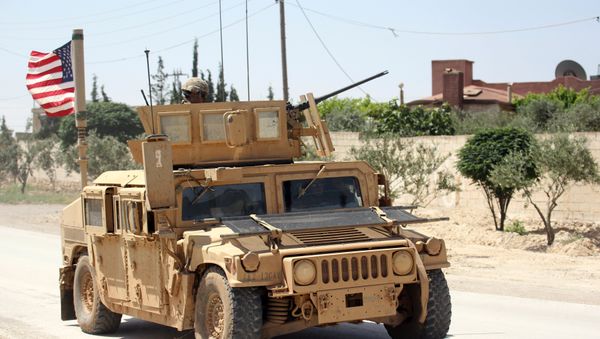 The U.S. flag flutters on a military vehicle in Manbej countryside, Syria May 12, 2018 - Sputnik International