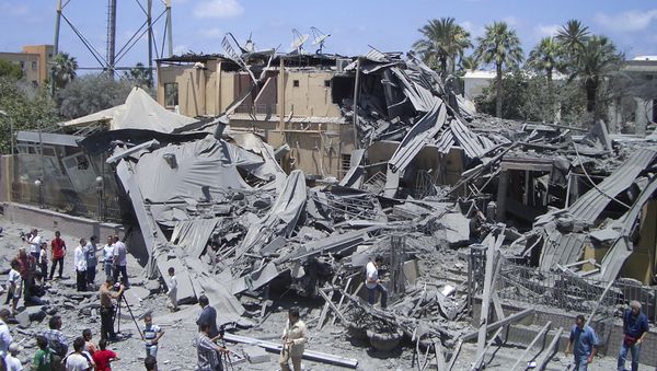 In this photo taken on a government-organized tour, media film damage from what officials said was a NATO airstrike at a hotel, in the capital Tripoli, Libya Thursday, June 16, 2011, while what officials described as a telecommunications tower is seen at left In this photo taken on a government-organized tour, media film damage from what officials said was a NATO airstrike at a hotel, in the capital Tripoli, Libya Thursday, June 16, 2011, while what officials described as a telecommunications tower is seen at left - Sputnik International
