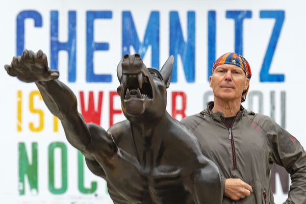 Artist Rainer Opolka stands besides of one of his sculptures near the Karl Marx Monument in Chemnitz - Sputnik International