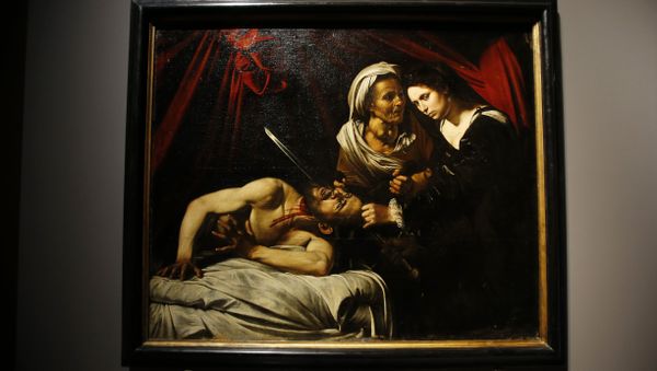 A painting believed to be the Judith Beheading Holofernes by the Italian baroque master Michelangelo Merisi da Caravaggio is displayed at the Brera Gallery in Milan, Italy, Monday, Nov. 7, 2016. The director of the Brera Art Gallery has courted controversy by including in a new show a painting whose attribution to Caravaggio is disputed. Critics charge that the decision to display “Judith Beheading Holofernes,” discovered two years ago in an attic in southern France, legitimizes the attribution to Caravaggio and would drive up the work’s price were it to be put on the market - Sputnik International