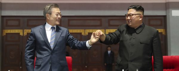South Korean President Moon Jae-in, left, and North Korean leader Kim Jong Un hold their hands after watching the mass games performance of The Glorious Country at May Day Stadium in Pyongyang, North Korea, Wednesday, Sept. 19, 2018. Unification flag symbol at top centre. South Korean President Moon Jae-in, left, and North Korean leader Kim Jong Un hold their hands after watching the mass games performance of The Glorious Country at May Day Stadium in Pyongyang, North Korea, Wednesday, Sept. 19, 2018. Unification flag symbol at top centre. - Sputnik International