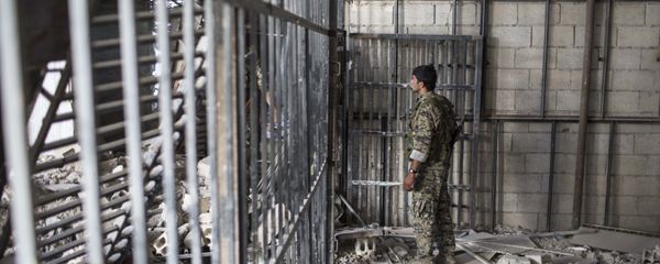 A member of the U.S.-backed Syrian Democratic Forces (SDF) walks inside a prison built by Islamic State fighters at the stadium that was the site of Islamic State fighters' last stand in the city of Raqqa, Syria, Friday, Oct. 20, 2017 - Sputnik International