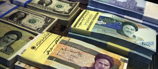 In this April 4, 2015 file photo, Iranian and U.S. banknotes are on display at a currency exchange shop in downtown Tehran, Iran In this April 4, 2015 file photo, Iranian and U.S. banknotes are on display at a currency exchange shop in downtown Tehran, Iran - Sputnik International