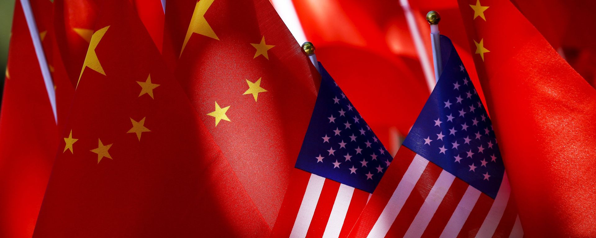 In this Sept. 16, 2018, photo, American flags are displayed together with Chinese flags on top of a trishaw in Beijing.  - Sputnik International, 1920, 25.04.2025