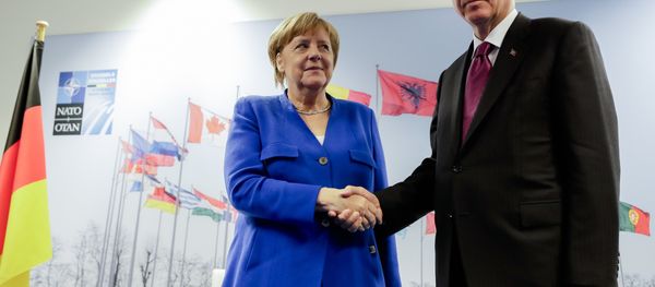 German Chancellor Angela Merkel, left, and Turkish President Recep Tayyip Erdogan, right, shake hands prior to a bilateral meeting on the sideline of a summit of heads of state and government at NATO headquarters in Brussels Wednesday, July 11, 2018 German Chancellor Angela Merkel, left, and Turkish President Recep Tayyip Erdogan, right, shake hands prior to a bilateral meeting on the sideline of a summit of heads of state and government at NATO headquarters in Brussels Wednesday, July 11, 2018 - Sputnik International