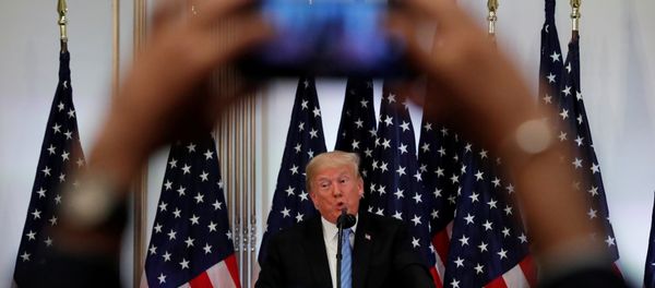 A reporter uses his mobile phone to record U.S. President Donald Trump at a news conference on the sidelines of the 73rd session of the United Nations General Assembly in New York, U.S., September 26, 2018 - Sputnik International