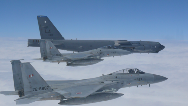 A US Air Force B-52H Stratofortress bomber and two Koku Jieitai (Japan Air Self-Defense Force) F-15 fighters execute a routine bilateral training mission over the East China Sea and the Sea of Japan, Sept. 26, 2018. - Sputnik International