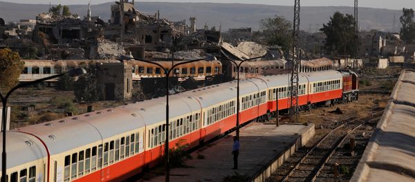 Damaged buildings are seen next a railway station in Damascus Damaged buildings are seen next a railway station in Damascus - Sputnik International