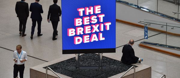 Delegates are seen near a sign that reads The Best Brexit Deal at the venue on the first day of the Conservative Party Conference 2018 at the International Convention Centre in Birmingham, on September 30, 2018. - Sputnik International